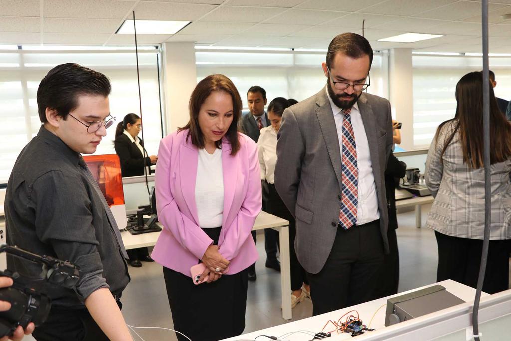 Several individuals dressed in suits and ties are focused on a computer, engaged in discussion.